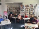 Zdjęcie przedstawia ludzi w bibliotece