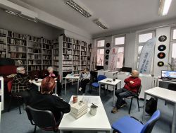 Zdjęcie przedstawia ludzi w bibliotece